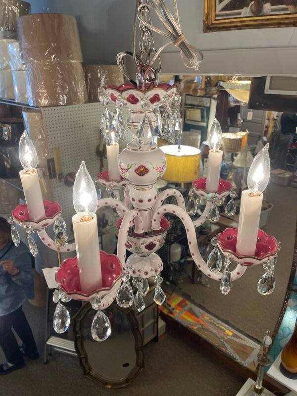 “Cottage chic chandelier with pink arms and candle bulbs”