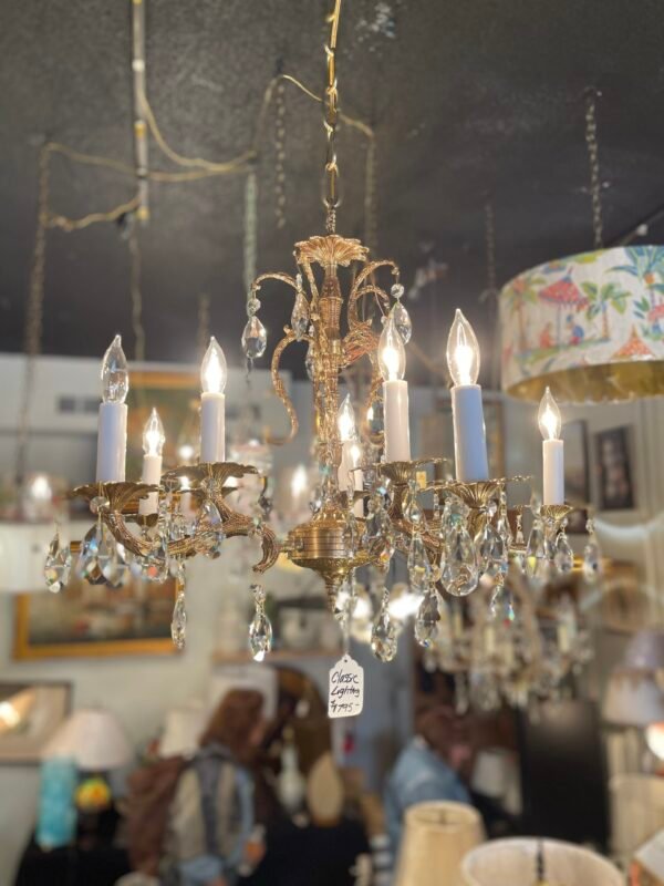 close-up of antique leaf-arm chandelier with crystals
