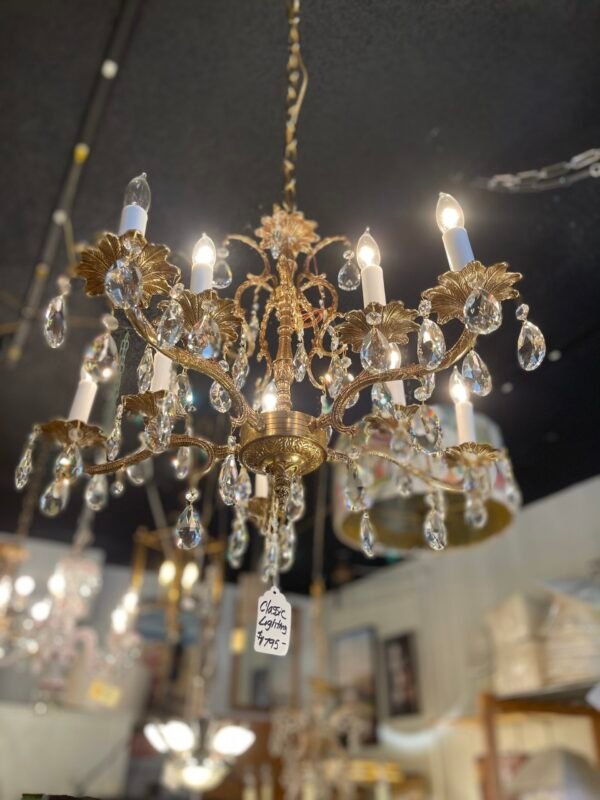 ornate chandelier hanging in vintage lighting store