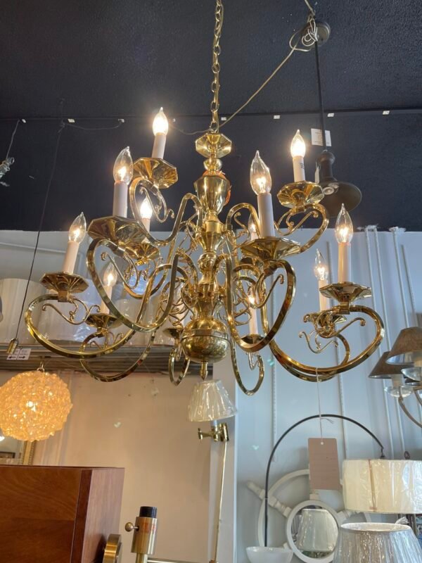 "Close-up of brass chandelier showing ornate detailing"