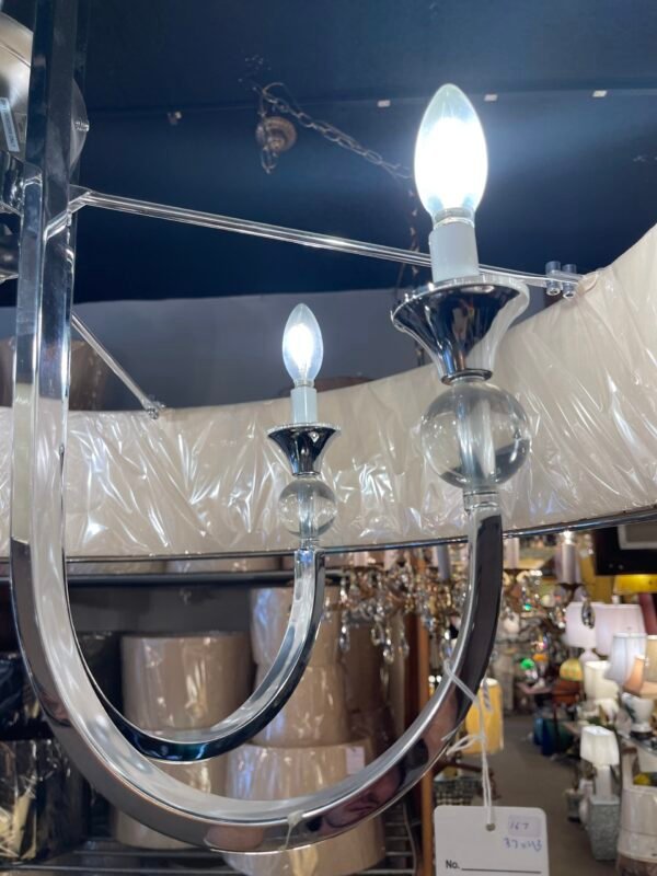 Candle-arm detail with crystal orb on chrome chandelier