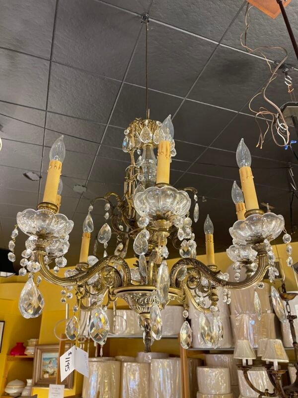 Brass chandelier with floral scrollwork and bobeches