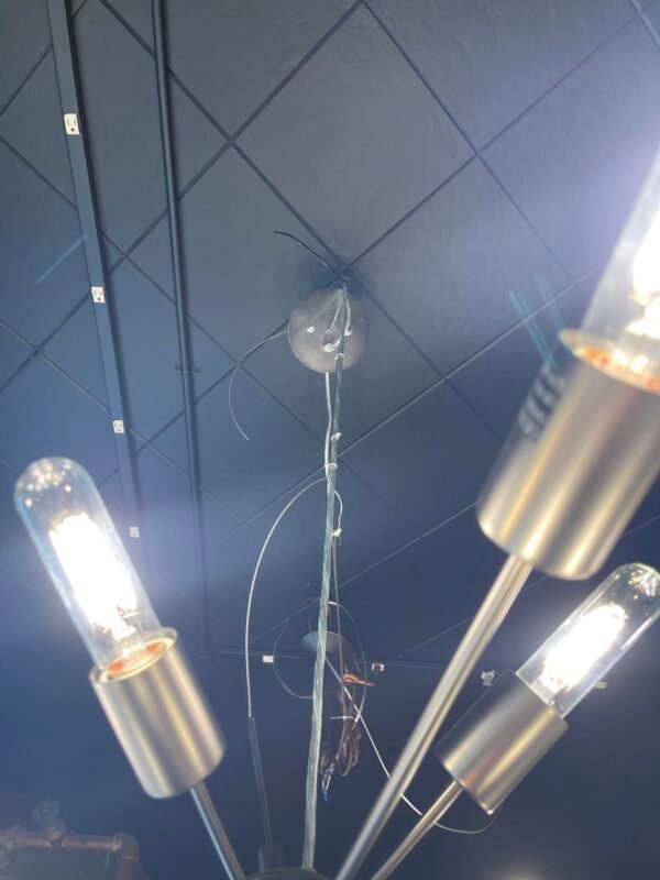 Modern brushed steel Sputnik chandelier with 12 tubular bulbs suspended from a central sphere