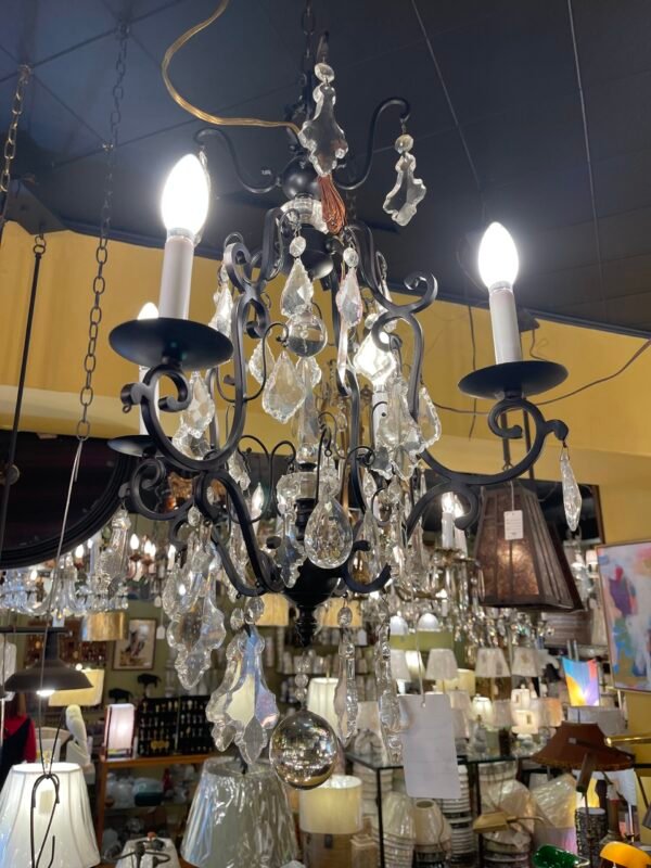 Black wrought iron chandelier with crystal prisms and ball finial