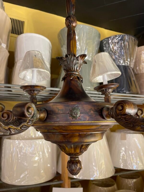 Close-up of ornate chandelier arm with scroll design
