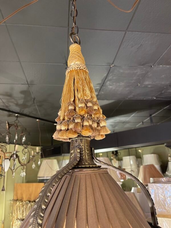 Hanging light with gold tassel and bronze trim