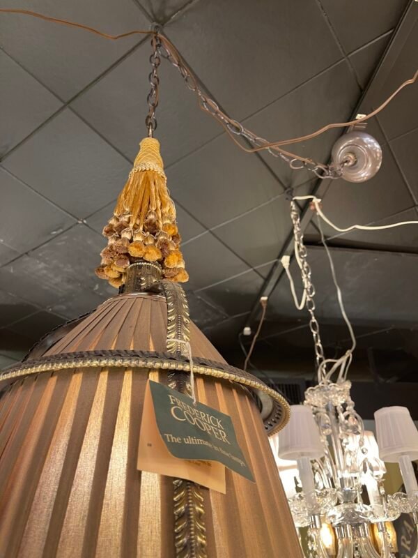 Hanging light with gold tassel and bronze trim