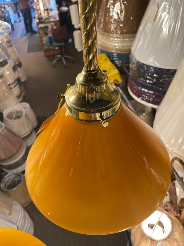 Twisted brass stem on hanging amber glass light