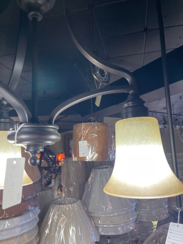 Curved arm chandelier with warm glass shades