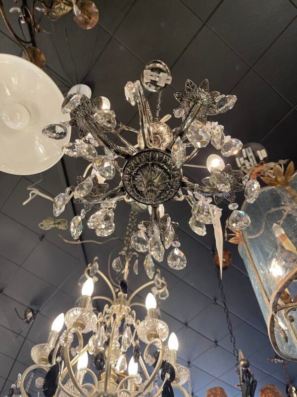 Close-up of faceted crystal drops on silver chandelier