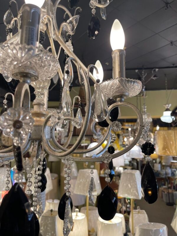 Elegant scroll-arm chandelier with candle lights