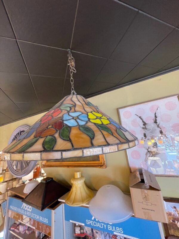 Colorful antique stained glass pendant light with floral pattern in blue, yellow, red, and green
